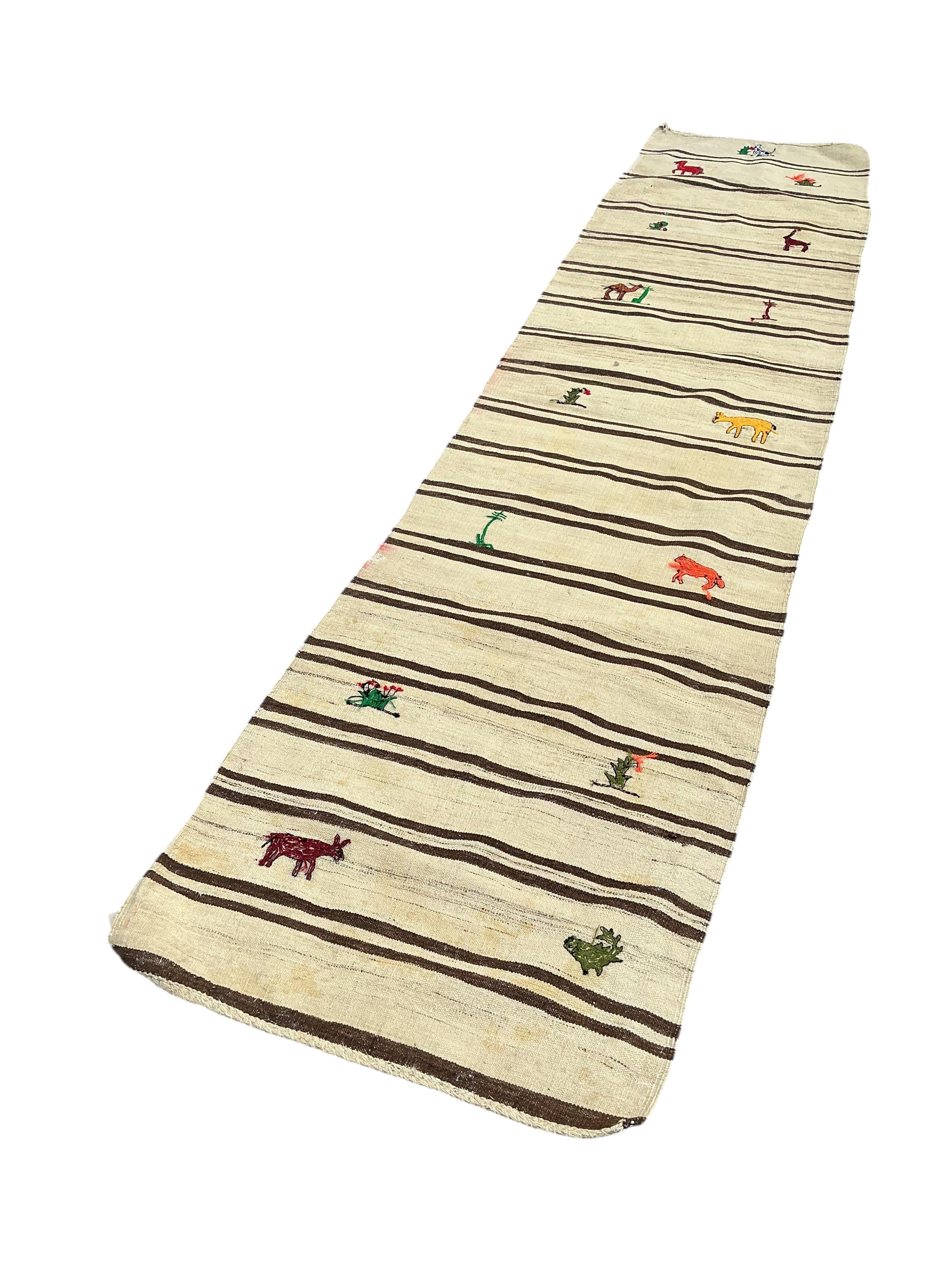 A Turkish kilim flat weave runner woven with animals and flowers, 370 x 82cm